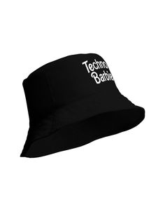 Become the rave's ultimate Techno Barbie! Whether you're vibing to heavy beats or chilling with friends, our Techno Barbie Black Bucket Hat adds the perfect touch of nostalgic sass to your rave attire. It's not just a hat; it's a vibe. Featuring the sassy "Techno Barbie" script in the iconic font on breathable premium fabric, this bucket hat guarantees you're always on-trend. Its moisture-wicking abilities ensure you stay cool, while the linen-feel offers an added touch of luxury. Distinct "Tech Trendy Black Hat For Music Festival, Casual Black Hat For Music Festival, Adjustable Black Bucket Hat With Letter Print, Casual Black Bucket Hat For Festivals, Retro Black Adjustable Bucket Hat, Black Cotton Hat For Festivals, Retro Adjustable Black Bucket Hat, Black Cotton Festival Hat, Black Hip Hop Hat For Festival