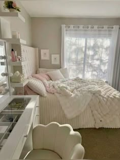 a bedroom with a large bed and white furniture