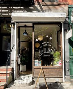 a store front with an open window and sign on the door that says miconco bakery