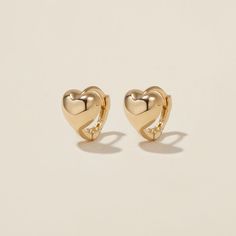 Heart goes padam padam in these hoops. Boo’s chubby heart motif, set on a 6mm huggie, are the sweetest addition to your ear stack. Minimal, sophisticated and chic, these shapely hoops will have hearts skipping beats. Created for you in the finest 14 karat gold, you'll want to wear these earrings always and never take them off, even when working out or in the shower. Gold Huggie Heart Earrings Trendy, Dainty Tarnish-resistant Huggie Heart Earrings, Gold Plated Heart Huggie Earrings, Gold Plated Huggie Earrings With Heart Charm, Gold Heart Charm Huggie Earrings, Padam Padam, Huggie Earrings Gold, Heart Motif, Ear Stack