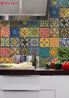 colorful tile backsplash in a kitchen with vegetables on the counter