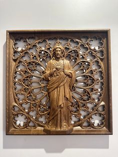 an intricately carved wooden wall panel with a statue