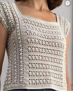 a woman is wearing a white crochet top