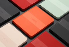 many different colors of electronic devices are arranged in the same pattern, including red, white, and black