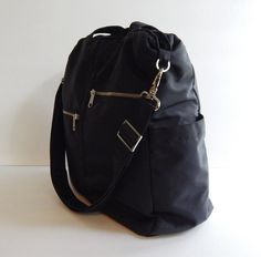 *** Please check 'shop announcement' for production time and delivery before your purchase. ***This sturdy bag is made from black water resistant nylon with black nylon lining. It's very roomy and suitable to be used as your all purpose bag, diaper bag, school bag, messenger bag, everyday tote, travel bag and messenger bag. You can just use the wet cloth to wipe the dirt out once it's get dirty.If you would rather have the bag in different colors (exterior and interior), please select your choic Aztec Bag, Cute School Bags, Bag School, Everyday Tote, Black Water, Overnight Bag, Bag Travel, Womens Purses, Black Nylon