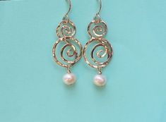 Double Wave Earrings, Gold Swirl Dangle Earrings, Double Swirl Earrings with Pearl Dangles 💙  SPECIAL EARRINGS These earrings are special because they are an original design. Because these earrings are an original design, they are a very unique gift for you or a friend!  Also, I first made them with silver wire, like most of my jewelry.  But after asking friends & customers if they wanted some items made in gold I got a resounding yes!  So here they are! 💙  HOW THEY WERE CREATED These earrings are hand forged with gold fill wire.  I then gently hammer each earring  to create a bright, delicate, artsy look!  They hang from gold fill ear wires.  And have freshwater pearl dangles. I hope you enjoy wearing these earrings as much as I enjoyed making them! 💙  ORIGINAL DESIGN Because these ear Elegant Swirl Wire Wrapped Earrings, Wire Wrapped Swirl Earrings, Elegant Swirl Shaped Pierced Earrings, Special Earrings, Cross Necklace Simple, Wave Earrings, Boho Cuff Bracelet, Boho Pendant Necklace, Boho Bangle