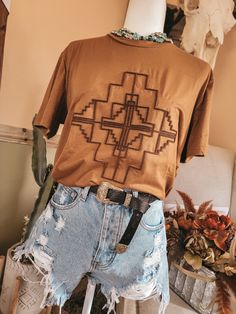 Zoom on in. It’s our new way to graphic tee. It’s an embroidered brush type technique that gives you some cool texture to rev up any ol t-shirt. And we are super Excited to bring you SOMETHING DIFFERENT. it's got a really RAD southwestern aztec graphic. it's giving serious desert vibes. saddle body. contrasting rust brush embroidery. regular-sized fit. running true to size. Brush Embroidery, Mom Graphic Tees, Western Graphic Tees, Western Style Outfits, Desert Vibes, Brush Type, Cute Preppy Outfits, Girl Fits, Western Boho