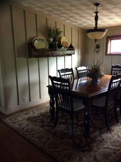 a dinning room table and chairs in front of a window