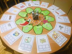 a wooden table topped with lots of cards on top of it