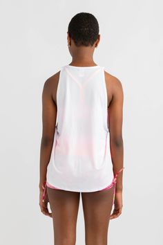 Throw it on and forget it. The ideal style singlet tank top to layer over crop tops. Designed in a crisp white colour with large neon pop Every Turn logo. Styled in a looser fitting shape with a higher round neckline and dropped armholes. White Stretch Tank Top For Streetwear, White Crew Neck Tank Top For Athleisure, White Crew Neck Tank Top Athleisure, White Racerback Tank Top For Summer, White Summer Racerback Tank Top, Summer Muscle Tee With Graphic Print In Athleisure Style, Summer Gym Tops With Dropped Armholes, Summer Athleisure Muscle Tee With Graphic Print, Summer Graphic Print Muscle Tee In Athleisure Style