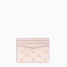 a pink card case with hearts on it