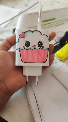 a person is holding a cupcake shaped charger