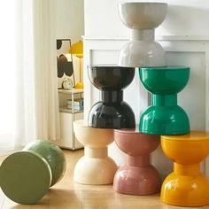 there are many different colored vases on the floor