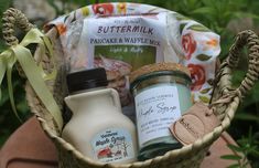 a basket filled with different types of food and condiments in front of some plants