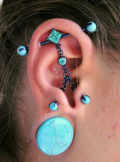 an ear with some piercings attached to it