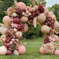 two large balloons are decorated with flowers and leaves