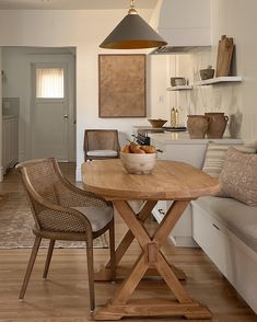 a wooden table sitting in the middle of a kitchen