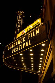 a sign that reads sundae film festival on the side of a building at night