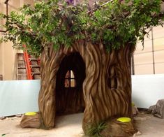 a fake tree stump house with trees growing out of it