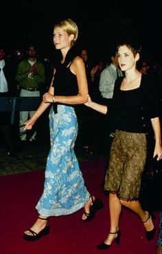 two women are walking down the red carpet