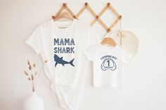 Shark Family Birthday Shirts This classic unisex jersey short sleeve tee fits like a well-loved favorite. Soft cotton and quality print make users fall in love with it over and over again. These t-shirts have-ribbed knit collars to bolster shaping. The shoulders have taping for better fit over time. Dual side seams hold the garment's shape for longer. -100% Airlume combed and ring spun cotton (fiber content may vary for different colors) -Light fabric (4.2 oz/yd² (142 g/m - Retail fit - Tear awa First Birthday Graphic Tee With Short Sleeves, First Birthday Custom Print Short Sleeve T-shirt, Short Sleeve Shirt For First Birthday In Summer, First Birthday Summer T-shirt With Crew Neck, White T-shirt For First Birthday In Summer, Shark Tee, Family Birthday Shirts, Birthday Party Outfits, First Birthday Shirts