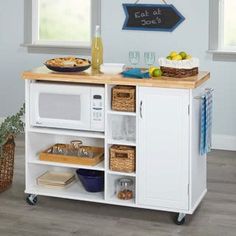 a kitchen island with food and drinks on it in front of a blue painted wall