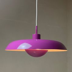 a purple light hanging from a ceiling in a room