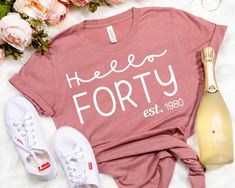 a t - shirt that says, hello twenty one next to some shoes and flowers