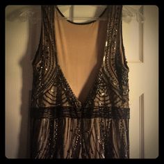 a black and gold dress hanging up on a hanger in front of a door