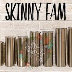 the skinnyy fam coffee cups are lined up in front of a brick wall