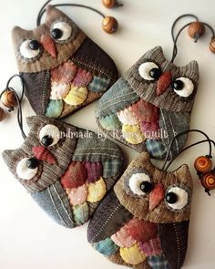 four owls are hanging on the wall with eyes and hearts attached to it's pouches