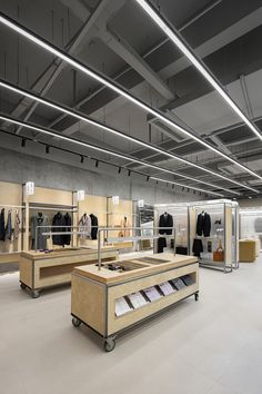 the inside of a clothing store with clothes on display