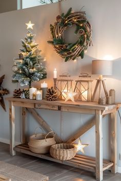 a christmas tree is on top of a wooden table with candles and other decorations around it