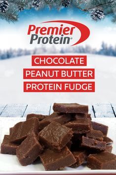 chocolate peanut butter protein fudge on a white plate with pine tree in the background