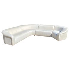 a large white couch sitting on top of a white floor