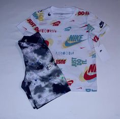 New Never Worn With Tags. Nike Set Includes A White Printed Short Sleeve Cotton Blend Tee With Red, Green, Blue, Yellow And Multi Trim And "Nike" Inscription And Classic Check Logo On Front And Left Sleeve. Bottoms Are Black Spotted Multi Color Cotton Blend Design With White Trim And Elastic Waistline And Nike Check Logo On Left Leg. 2 Pocket Design With Draw Cord. Set Fits 7 Youth Boys. Any Questions, Please Contact Me. Thanks! Check Logo, Nike Set, Cord Set, Nike Boys, Nike Boy, Tee Set, Pajama Shirt, Kids Nike, Fit N Flare Dress