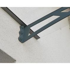 the corner of a building with metal brackets on it