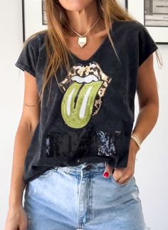 a woman wearing a t - shirt with the rolling stones on it's chest