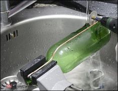 a green bottle sitting on top of a metal sink