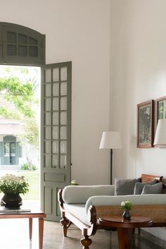 a living room filled with furniture next to a doorway