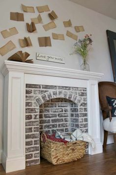 a basket is sitting on top of a brick fireplace with many pieces of paper stuck to it