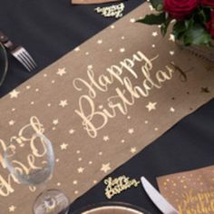 a table set for a birthday party with place settings and napkins on the table