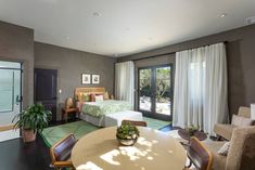 a living room filled with furniture next to a sliding glass door