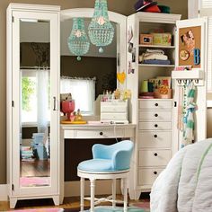 a bedroom with white furniture and lots of drawers