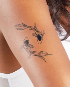 a woman with a tattoo on her arm has a koi fish in the water