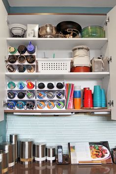 the shelves are filled with pots, pans, and other kitchen utensils