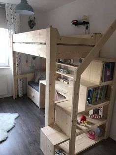 there is a bunk bed with stairs to the bottom and bookshelf on top