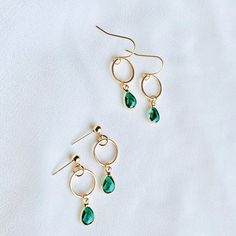 DAINTY CHIC STUNNERS! Glassy and dimensional, these faceted green gemstones pair beautifully with 18K gold hardware.  Ideal shade of 18K gold - not gaudy orange or gaudy yellow. SAFE FOR SENSITIVE SKIN  Free of nickel, lead, & metals that irritate the skin. Will not turn skin green. Lightweight and comfortable on the ears. ANTI-TARNISH 18K GOLD Base metal: brass - coated in 18k gold. Our gold layers are wonderfully thick and very tarnish-resistant. Durable for long term wear. SIZE  Emerald: ~.4" Dangle Earrings Gold, Green Gem, Earrings Teardrop, Gem Earrings, May Birthstone, Green Gems, Earrings Dainty, Emerald Earrings, Green Gemstones