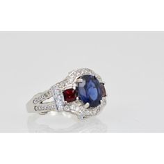 This is part of Chairish’s Fine Jewelry assortment.  Sapphire Ruby Diamond Ring 18K White Gold  This lovely Sapphire Ruby Diamond Ring is set in 14K White Gold. It features a Oval cut Sapphire weighing in at 2.67 Carats, flanked by 2 Rubys square cut and weighing 0.70 carats and White Diamonds, F-G, VS weighting in at 2.50 Carats. Set in a square shank mounting, measuring approximately 15mm tapering to 2.4mm Size 6.5. Total weight: 5.87 carats. I purchased this to go with many of my Tutti Frutti Formal Gia Certified Cushion Cut Ruby Ring, Luxury Multi-stone Sapphire Cluster Ring, Gia Certified Cushion Cut Ruby Ring For Formal Occasions, Luxury White Gold Multi-stone Sapphire Ring, Elegant Sapphire Multi-stone Cluster Ring, Formal Sapphire Cluster Ring With Diamond Cut, Elegant Multi-stone Sapphire Cluster Ring, Elegant Cushion Cut Ruby Ring In White Gold, Luxury Cubic Zirconia Formal Birthstone Ring