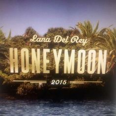 there is a sign that says honey moon in front of some water and palm trees